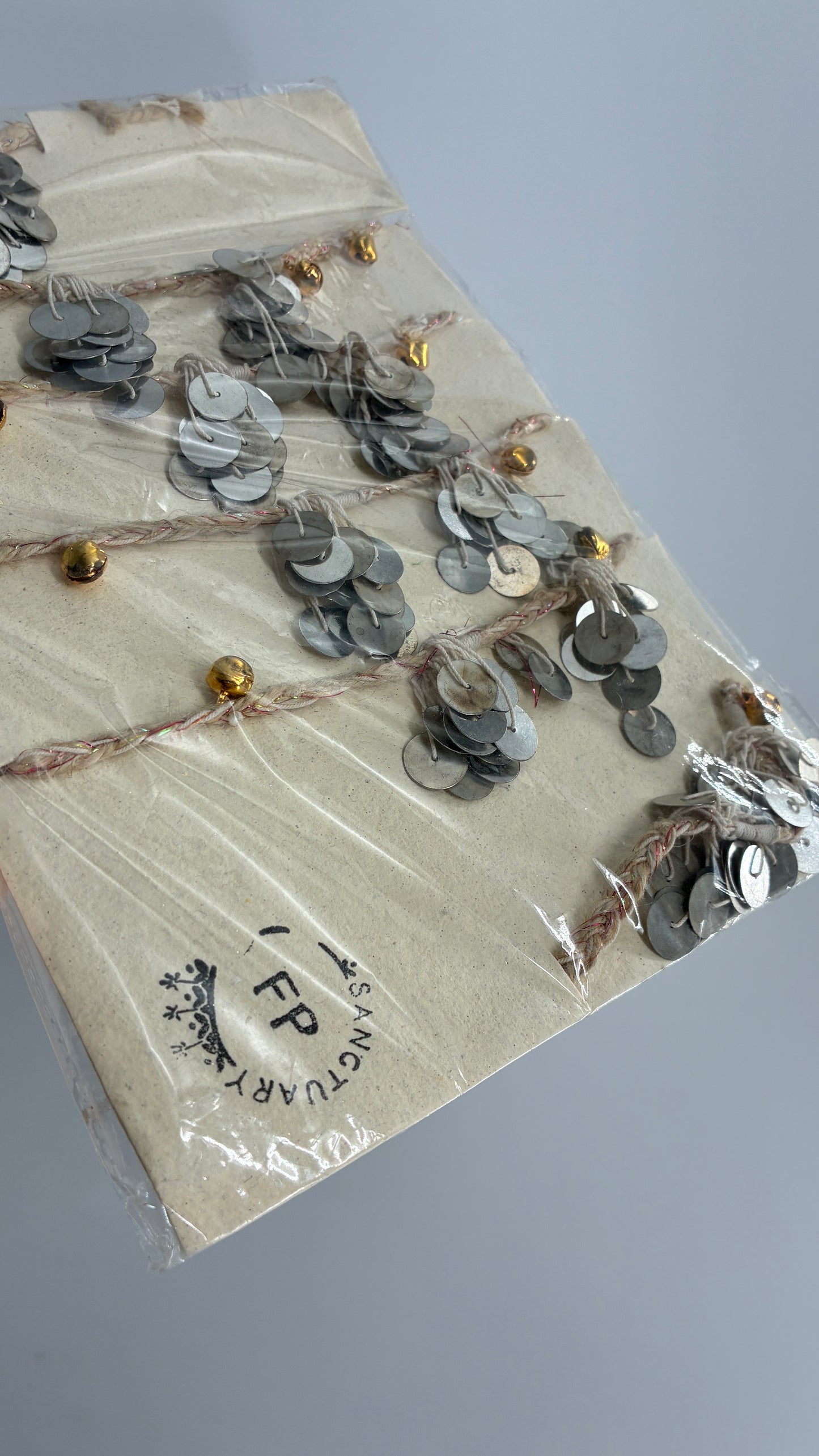Free People Silver Metal Coin Garland with Gold Bell Detailing
