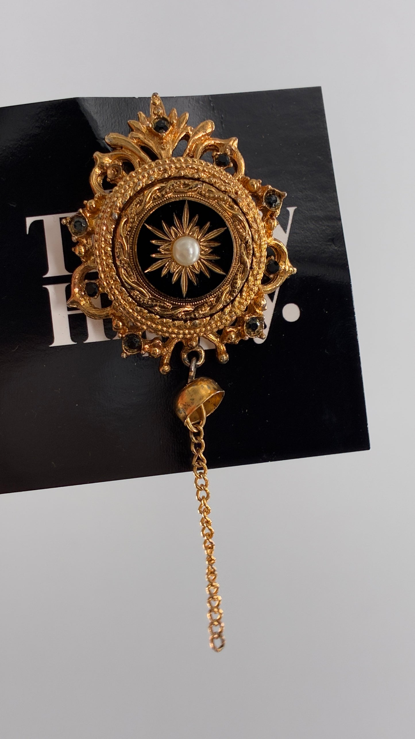 Vintage Victorian Revival Gold Brooch with Black Glass, Starburst Motif, Faux Pearl Centerpiece and Dangling Chain