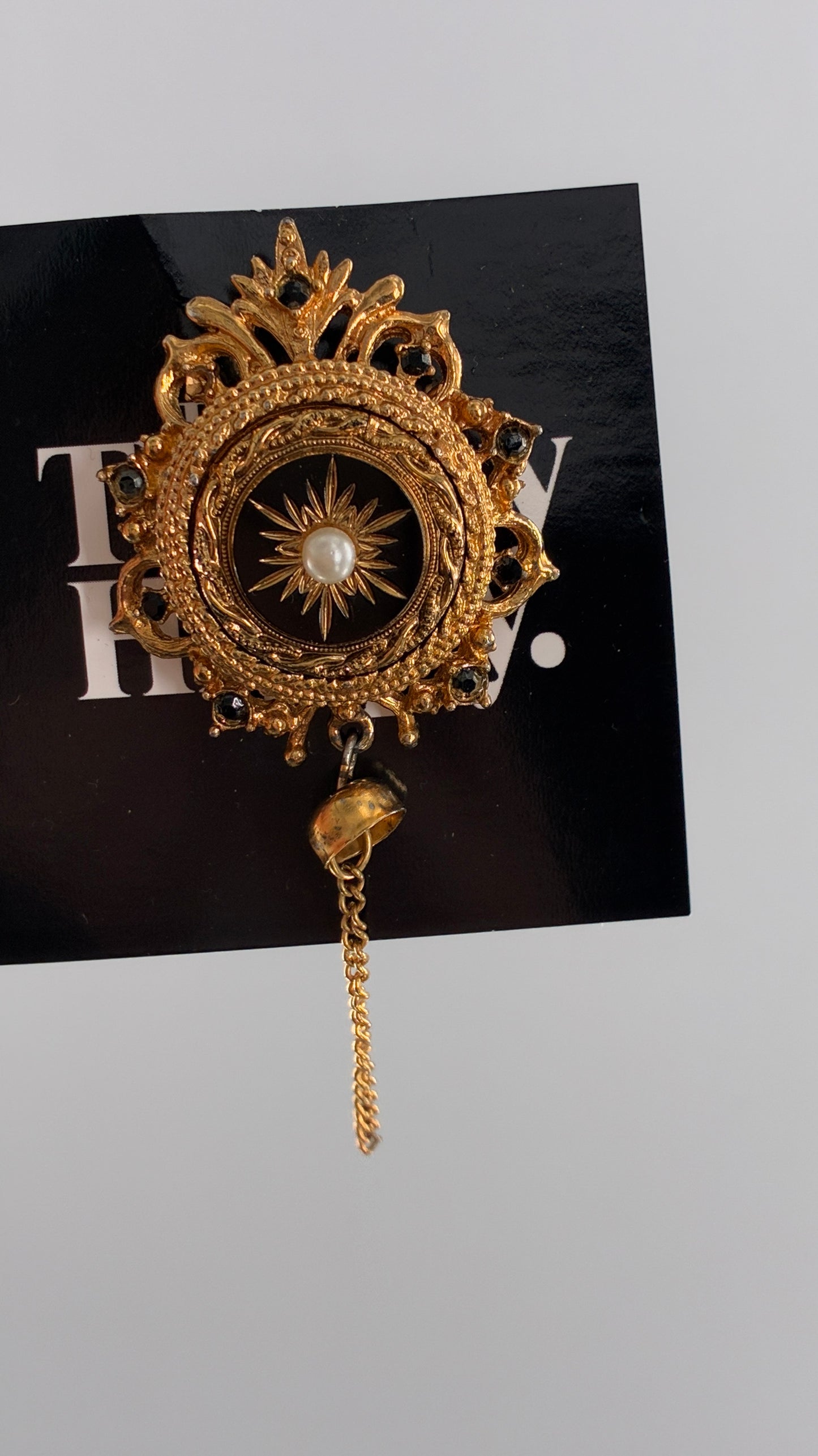 Vintage Victorian Revival Gold Brooch with Black Glass, Starburst Motif, Faux Pearl Centerpiece and Dangling Chain